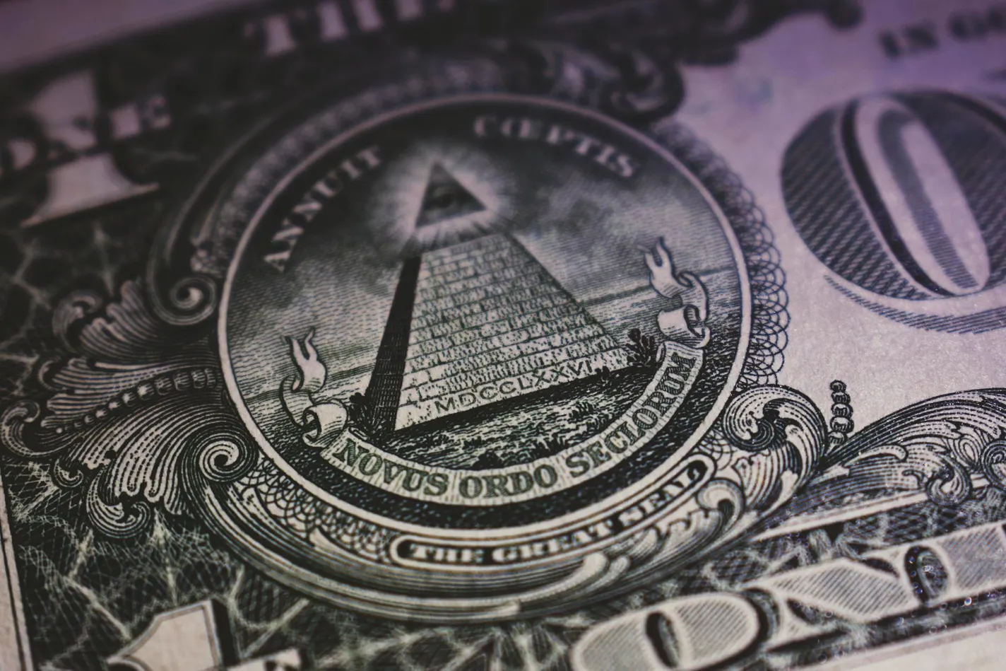 A close-up view of the Great Seal of the United States, featuring the pyramid with the Eye of Providence, the Latin phrase 'Novus Ordo Seclorum', and the year 'MDCCLXXVI' inscribed at the base.
